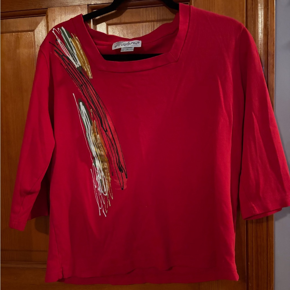 Super cute red top with a splash of color over the right shoulder.